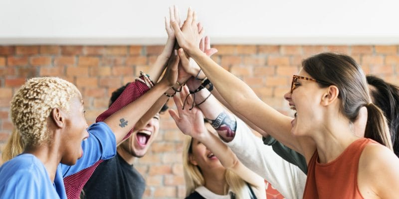 group of people high fiving