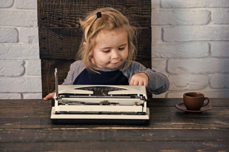kid using typewriter