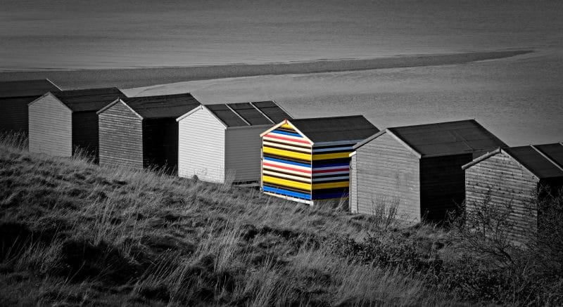 colorful shed among black sheds