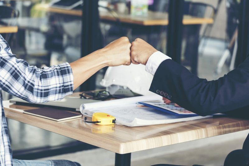 The Ultimate 2022 Guide to Law Firm Branding 2 two people fist bumping