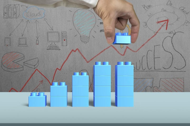 7 Key Law Firm KPIs to Track for Success 6 blue lego blocks showing upward graph