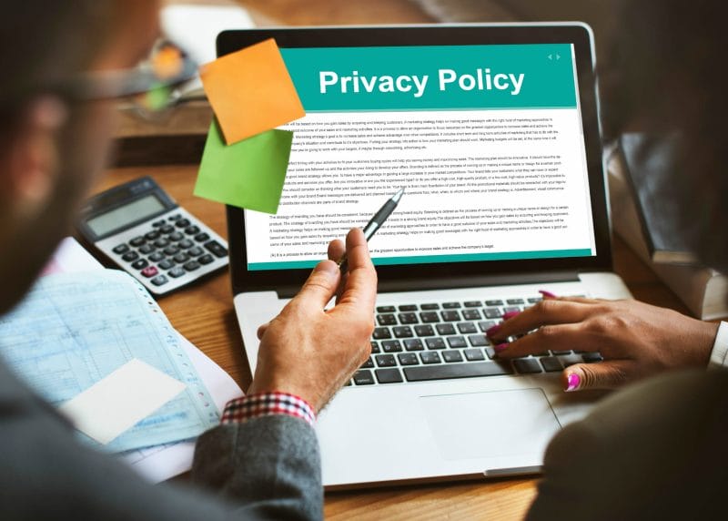 Blogging for Lawyers: How to Start & Grow Your Legal Blog 27 a man and a woman looking at a privacy policy page on a laptop